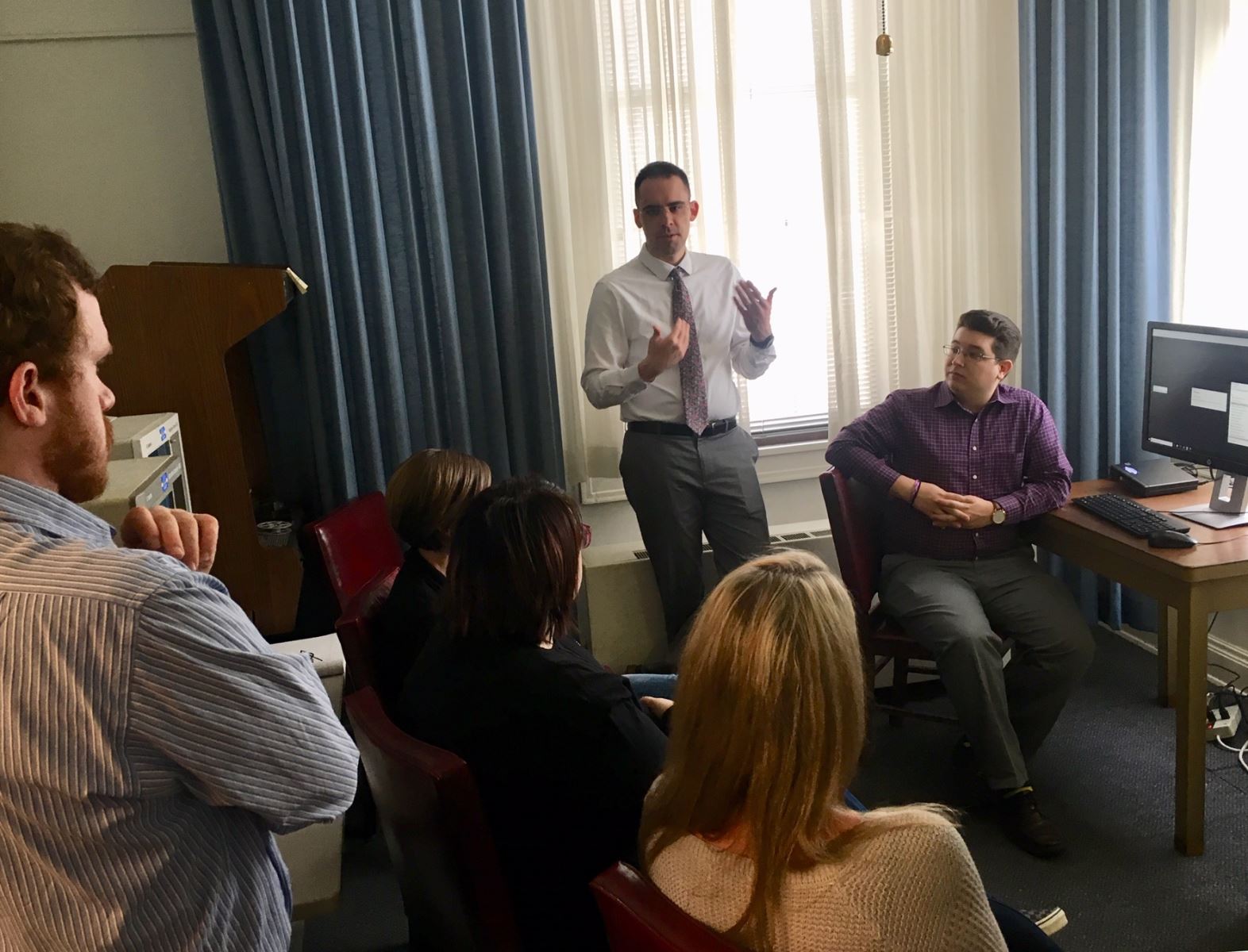 Brent West (standing) and Josh Hackel (seated) of the University of Illinois explain to Illinois State Archives staff